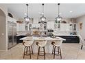 Modern kitchen featuring a large island, stainless steel appliances, and pendant lighting at 9668 Doraville Ave, Las Vegas, NV 89149