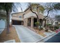 Charming two-story home with a spacious driveway and well-maintained landscaping at 10323 Hardy Falls St, Las Vegas, NV 89141