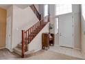 Bright foyer with a staircase, tiled flooring, and natural light from the windows at 10478 Beallsville St, Las Vegas, NV 89141