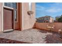 Cozy front patio features brick pavers and offers outdoor seating, creating an inviting space at 10478 Beallsville St, Las Vegas, NV 89141