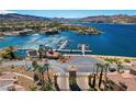Lakefront with marina, blue water, condos with tile roofs, and gate to the exclusive community at 15 Via Mantova # 308, Henderson, NV 89011