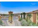 Inviting community entrance featuring a water view and lush greenery at 15 Via Mantova # 308, Henderson, NV 89011