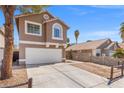Two-story home featuring a spacious driveway and desert-style landscaping, creating a welcoming curb appeal at 1892 Falcon Ridge St, Las Vegas, NV 89142