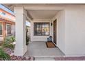 Charming front porch featuring stylish lanterns, decorative plants, and a welcoming entrance to the home at 2547 Wolverton Ave, Henderson, NV 89074