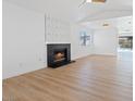Spacious living room featuring a brick fireplace, bright window, and an open layout perfect for entertaining at 2547 Wolverton Ave, Henderson, NV 89074