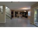 Open-concept layout seamlessly connects the living room and kitchen, with stairs leading to the second floor at 2822 Poseidon Shore Ave, Henderson, NV 89052