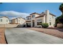 Stylish home with a tile roof, a spacious driveway, and low-maintenance desert landscaping at 293 Winter Creek Ct, Henderson, NV 89074