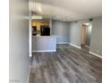 Open-concept living room and kitchen with sleek gray flooring and modern finishes at 2967 Juniper Hills Blvd # 104, Las Vegas, NV 89142