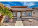 Front exterior view of a single story home with decorative front door and minimal desert landscaping at 3509 Altar Rock Ln, North Las Vegas, NV 89032