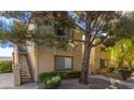 Attractive exterior of a two-story apartment building featuring stairs, landscaping, and multiple windows at 3673 Ian Thomas St # 201, Las Vegas, NV 89129