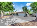 View of the expansive concrete driveway leading to the home's attached two-car garage at 3681 S Rosecrest Cir, Las Vegas, NV 89121