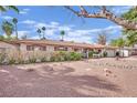 Well-kept single-story house with mature trees, desert landscaping, and a tidy exterior in a sunny setting at 3681 S Rosecrest Cir, Las Vegas, NV 89121