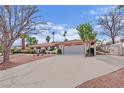 Spacious single-story home with a long driveway, a two-car garage, and a gated side entrance for added privacy at 3681 S Rosecrest Cir, Las Vegas, NV 89121