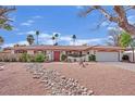 Inviting single-story home with well-maintained landscaping and a decorative rock feature leading to the front entrance at 3681 S Rosecrest Cir, Las Vegas, NV 89121