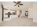 Open-concept living area features a staircase, chandelier and sleek modern kitchen at 3693 Canis Minor Ln # 13101, Henderson, NV 89052