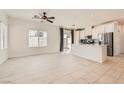 Bright living room boasts neutral tile flooring, a ceiling fan, and access to the patio at 3693 Canis Minor Ln # 13101, Henderson, NV 89052