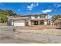 Lovely two-story home features a large garage, secure gate, and manicured gravel landscaping at 3916 Green Leaf Dr, Las Vegas, NV 89120