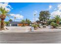 Beautiful single-story home boasting mature landscaping and well manicured desert flora at 401 Lacy Ln, Las Vegas, NV 89107