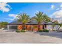 Beautiful single-story home boasting mature landscaping, a modern garage door, and decorative wooden fence at 401 Lacy Ln, Las Vegas, NV 89107