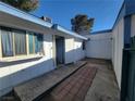 Exterior showcasing access to a quaint courtyard entry at 4032 Great Plains Way, Las Vegas, NV 89121