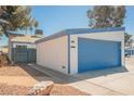 A lovely single story home showcasing a blue garage door and xeriscaped front yard at 4032 Great Plains Way, Las Vegas, NV 89121