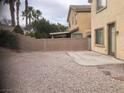 A neutral-toned backyard features gravel, a concrete patio, and a brick wall at 405 Center Green Dr, Las Vegas, NV 89148