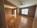 Spacious living room with hardwood floors, a ceiling fan, and natural light at 45 Maleena Mesa St # 1921, Henderson, NV 89074