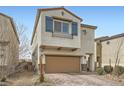 Charming home featuring a two-car garage, brick driveway, stylish shutters, and manicured landscaping at 4727 Agave Cactus St, North Las Vegas, NV 89031