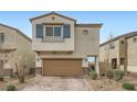 Charming home featuring a two-car garage, brick driveway, stylish shutters, and manicured landscaping at 4727 Agave Cactus St, North Las Vegas, NV 89031