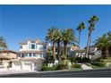 Stunning multi-story home with a three-car garage and well-manicured landscaping at 5020 Spanish Heights Dr, Las Vegas, NV 89148