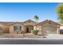 Charming single-story home featuring desert landscaping and a two-car garage at 5577 Golden Leaf Ave, Las Vegas, NV 89122