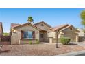 Attractive single-story home showcasing desert landscaping, shutters and a two-car garage at 5577 Golden Leaf Ave, Las Vegas, NV 89122