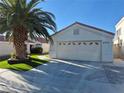 Charming single-story home featuring a two-car garage, terracotta roof and inviting desert landscaping with artificial turf at 6705 Old Newbury Ave, Las Vegas, NV 89108