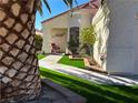 Inviting desert landscaping with artificial turf leads to this single story home with cozy front porch at 6705 Old Newbury Ave, Las Vegas, NV 89108