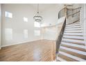 Bright living room featuring a staircase, high ceilings, and wood-look flooring at 7464 Forestdale Ct, Las Vegas, NV 89120