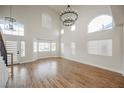 Open living room with high ceilings, wood-look floors, and many bright windows at 7464 Forestdale Ct, Las Vegas, NV 89120