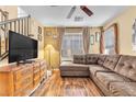 Comfortable living room area with a large television, wood floors, and ample natural light at 8932 Jaquita Ave, Las Vegas, NV 89149