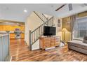 Open-concept living room showcases hardwood floors, a staircase, and seamless flow to kitchen at 8932 Jaquita Ave, Las Vegas, NV 89149