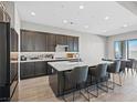 Modern kitchen featuring a large center island, quartz countertops, and stylish seating at 10186 Zeta Tucana St, Las Vegas, NV 89143