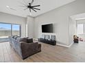 Spacious living room with tile floors, a ceiling fan, and a sliding glass door at 10186 Zeta Tucana St, Las Vegas, NV 89143