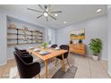 Dining room featuring a modern light fixture, stylish furnishings, and decorative shelving with neutral colors at 10373 Northern Hills Ave, Las Vegas, NV 89166