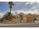 Charming single-story home with a lush palm tree and well-maintained landscaping at 1311 Watercreek Dr, North Las Vegas, NV 89032