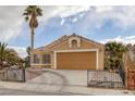 Inviting single-story home with a well-manicured front yard and a two-car garage at 1311 Watercreek Dr, North Las Vegas, NV 89032