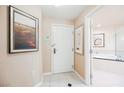 A bright foyer with tile flooring and artwork, leading to a bathroom with a soaking tub at 145 E Harmon Ave # 2007, Las Vegas, NV 89109