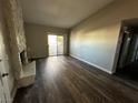 Spacious living room with hardwood floors, a stone fireplace and sliding door access to the outside at 1639 Justin Cir # 1639, Henderson, NV 89011