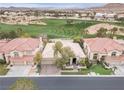 Stunning aerial view of a well-manicured property with a golf course backdrop, showcasing the home's prime location at 181 Cliff Valley Dr, Las Vegas, NV 89148