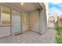 Exterior entrance featuring neutral colors, paver stones, and an arched gated entrance at 227 Badwater Basin St, Las Vegas, NV 89138