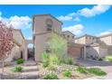 View of lovely two-story home with neutral stucco, stone driveway, archway, and landscaped front yard at 227 Badwater Basin St, Las Vegas, NV 89138