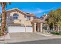 Charming two-story home with arched window, three car garage, and manicured landscaping at 2528 Furnace Creek Ave, Henderson, NV 89074