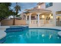 Inviting backyard pool featuring a covered patio and jacuzzi, perfect for outdoor relaxation at 2528 Furnace Creek Ave, Henderson, NV 89074